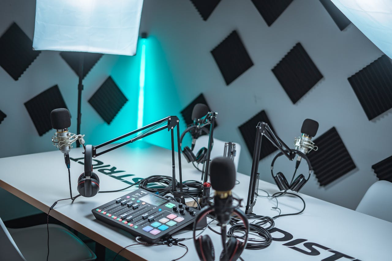 hero-img-01 Sleek podcast studio setup featuring microphones, audio mixer, and acoustic panels.